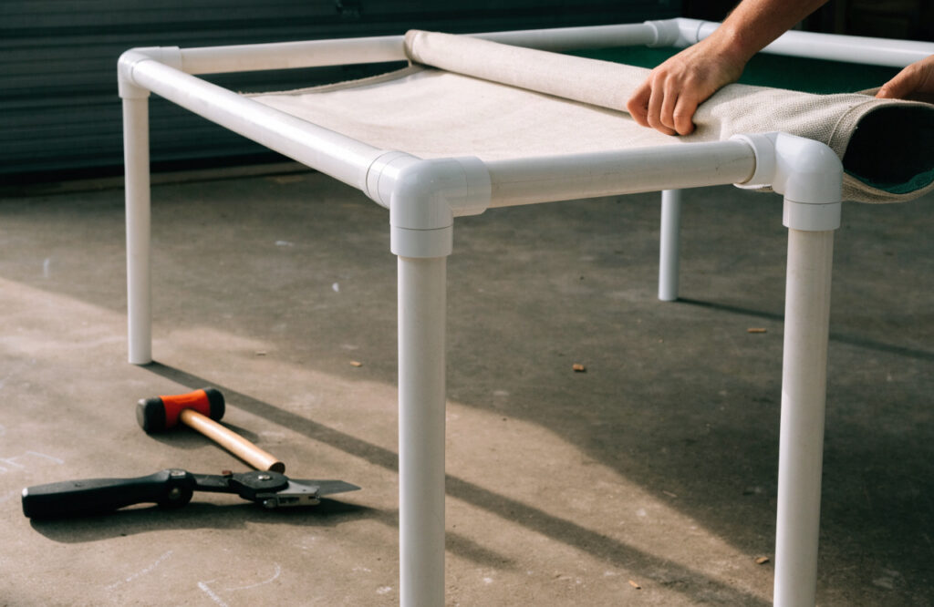 PVC pipe frame and canvas sling for a raised outdoor dog bed