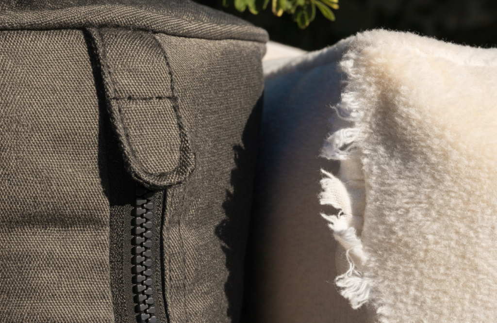 Ballistic nylon cover with a covered zipper beside torn fleece