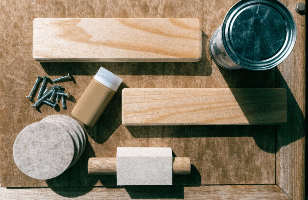 Sanded pine boards, wood glue, water-based finish, screws and felt pads for an indoor dog bed
